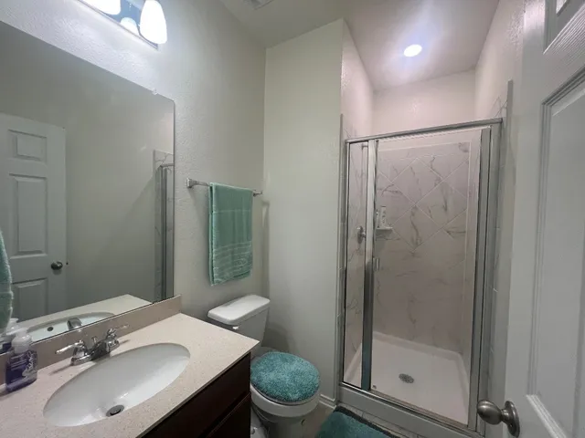 a bathroom with a sink toilet and shower