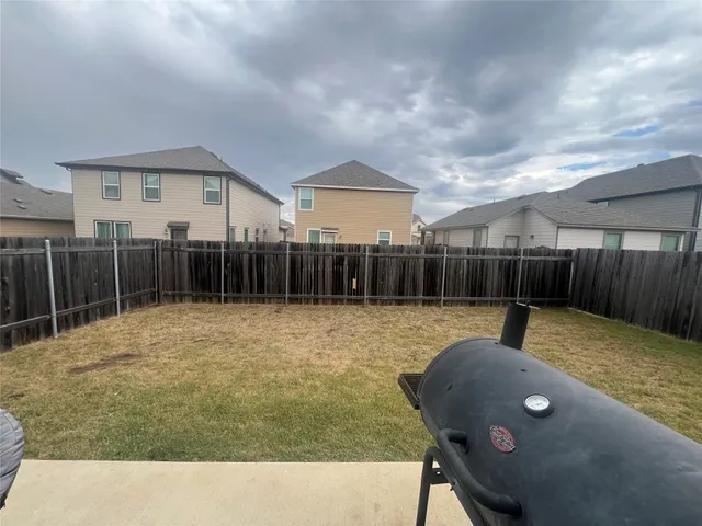 a view of a backyard with furniture