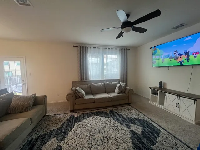 a living room with furniture and a rug