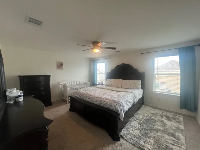 a bedroom with a bed and window