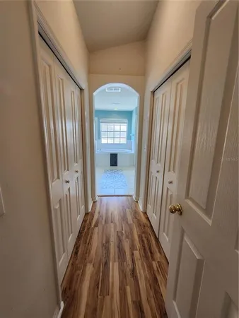 a view of a hallway view with wooden floor and staircase