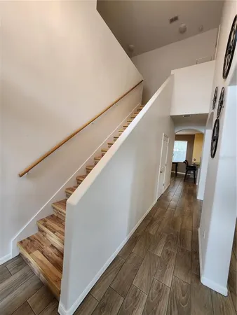 a view of entryway and hall with wooden floor