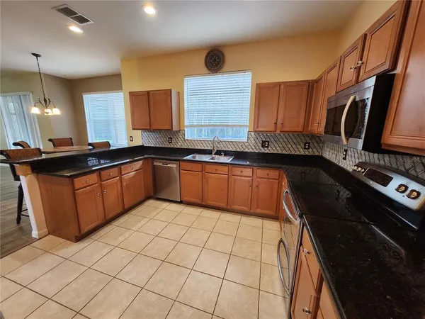 a kitchen with a sink stove and cabinets