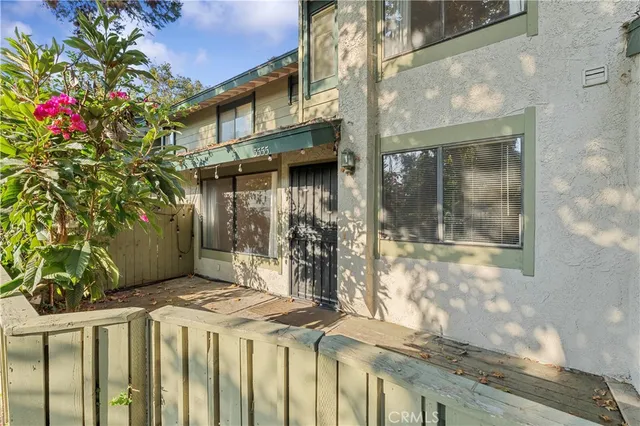 a view of a house with a tree in front