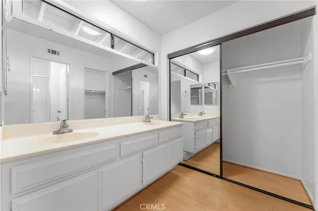 a bathroom with a double vanity sink mirror and shower