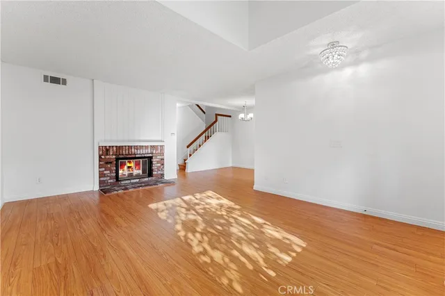 a view of a room with wooden floor and staircase