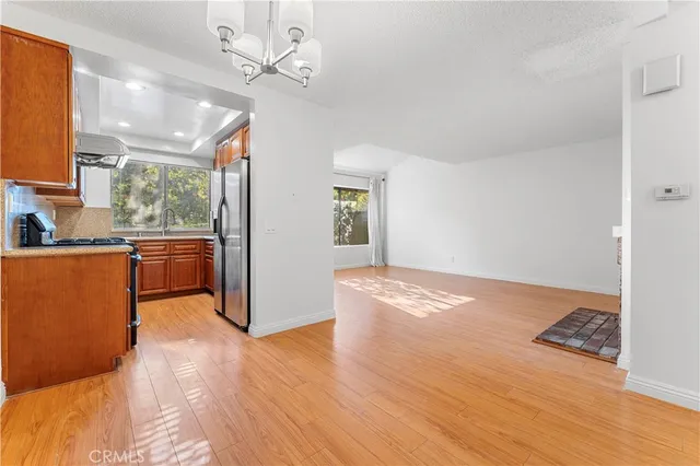 a view of a room with wooden floor and a ceiling fan