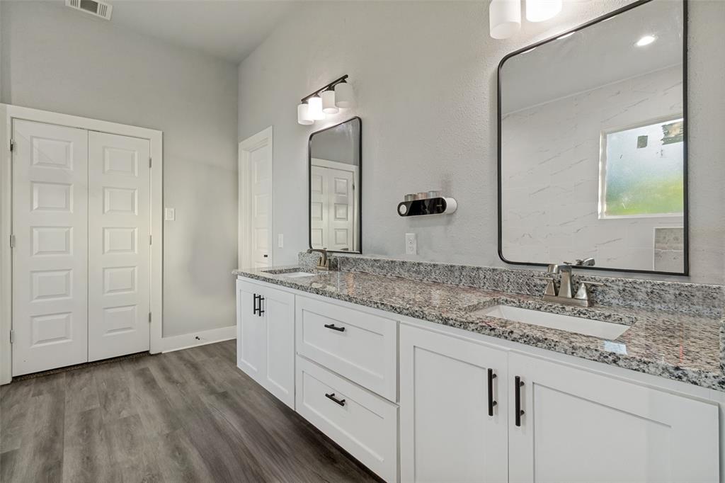 7909 Ivory Lane Dallas, TX 75216 - Photo 13 of 20 a bathroom with a granite countertop sink and a mirror