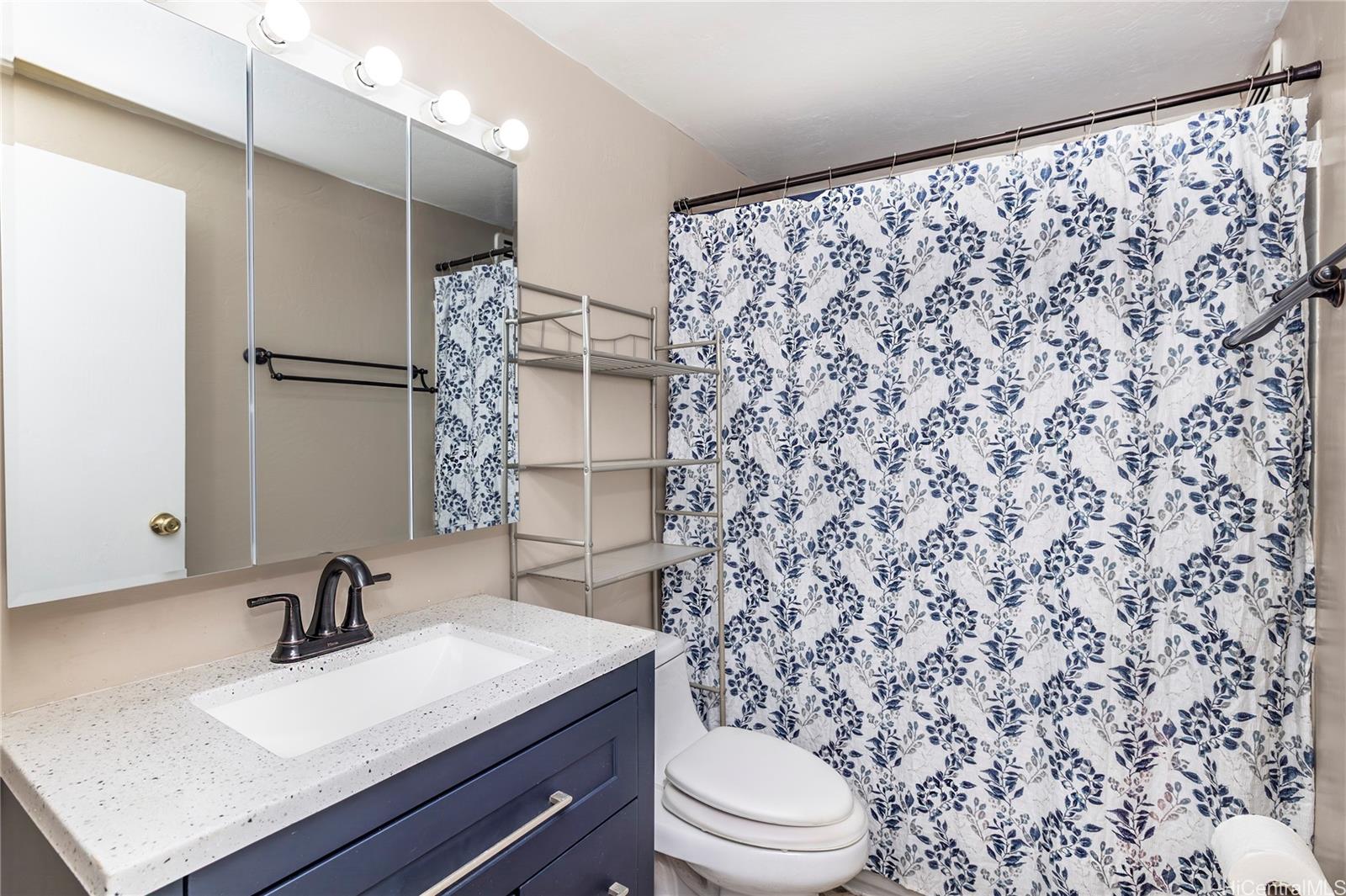 87-131 Helelua Street, Unit J304 Waianae, HI 96792 - Photo 12 of 19 a bathroom with a sink toilet a mirror and shower