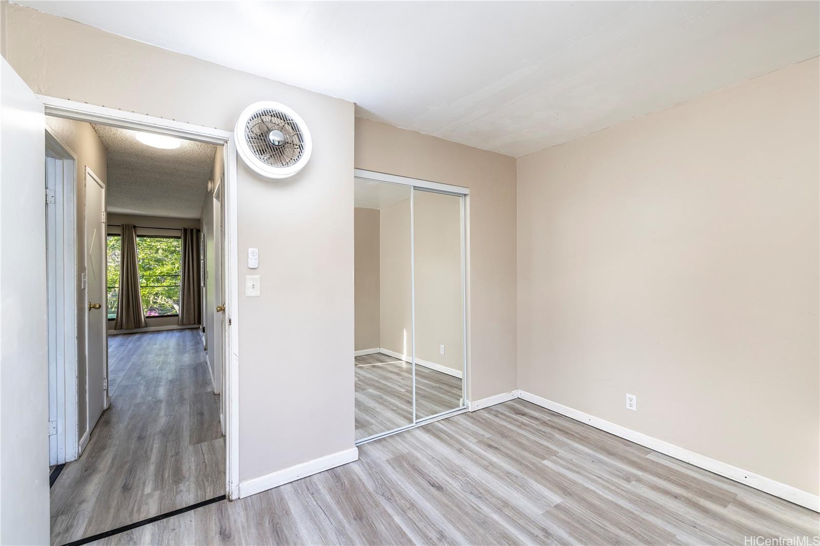 87-131 Helelua Street, Unit J304 Waianae, HI 96792 - Photo 13 of 19 a view of empty room with wooden floor