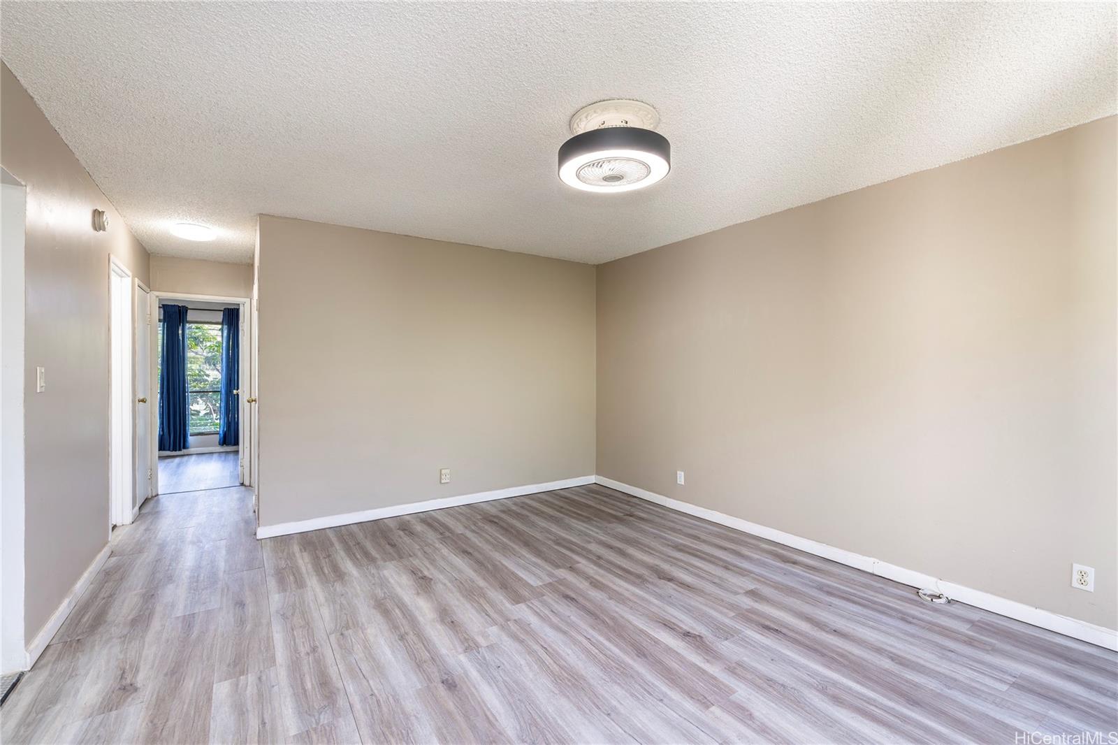87-131 Helelua Street, Unit J304 Waianae, HI 96792 - Photo 15 of 19 an empty room with wooden floor and windows