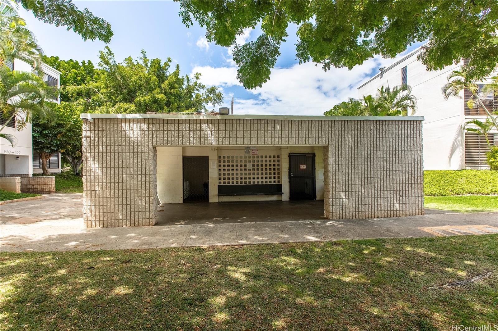 87-131 Helelua Street, Unit J304 Waianae, HI 96792 - Photo 16 of 19 a view of a house with backyard and garden