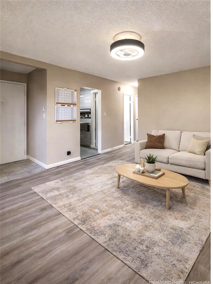 87-131 Helelua Street, Unit J304 Waianae, HI 96792 - Photo 4 of 19 a living room with furniture and a table