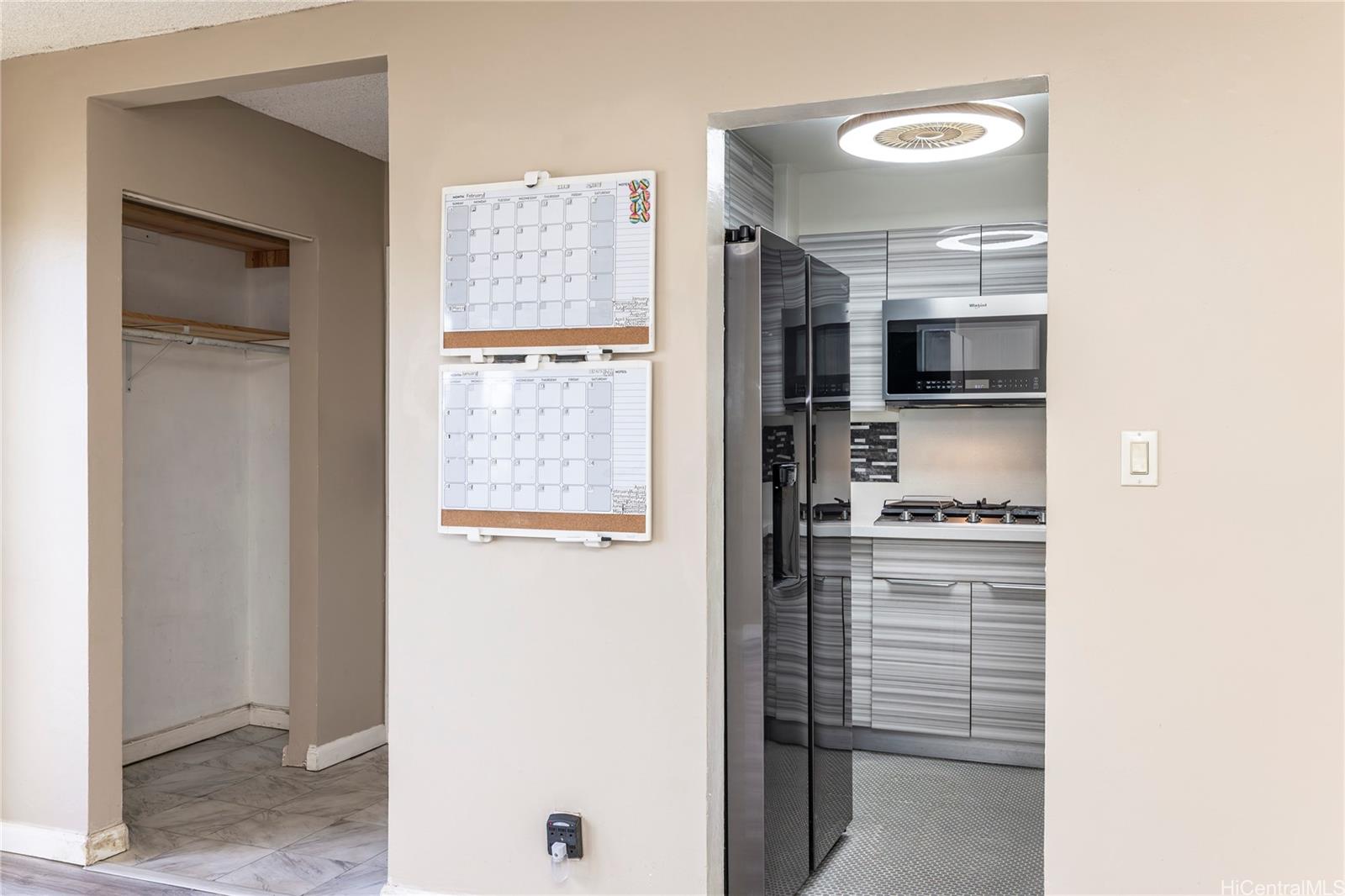 87-131 Helelua Street, Unit J304 Waianae, HI 96792 - Photo 10 of 19 a kitchen with a refrigerator and a stove