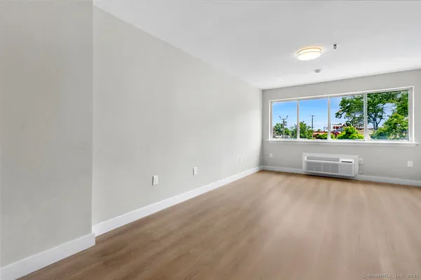 a view of a room with wooden floor and window