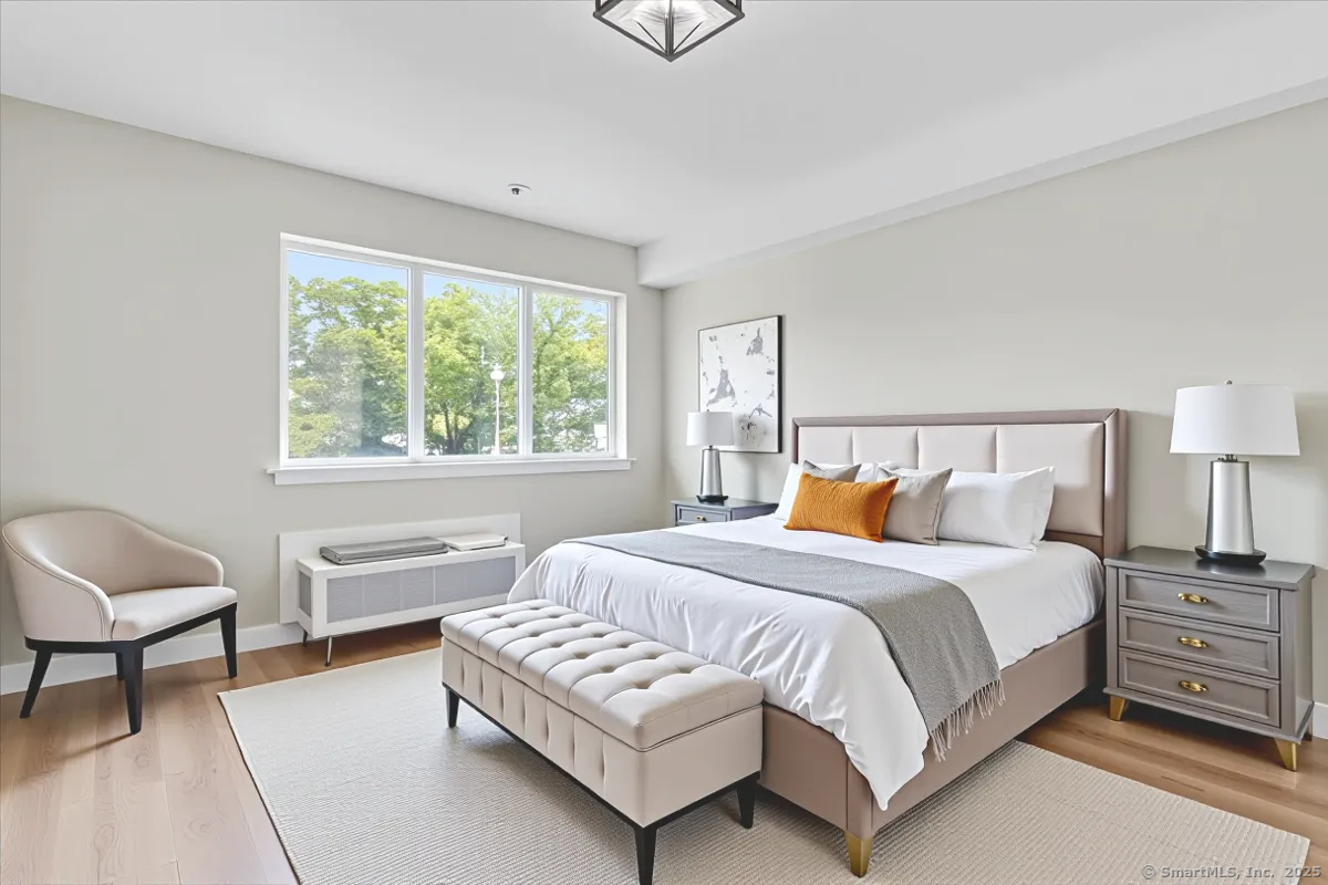 135 Gold Star Highway, Unit 402 Groton, CT 06340 - Photo 3 of 15 a bedroom with a bed and a chair