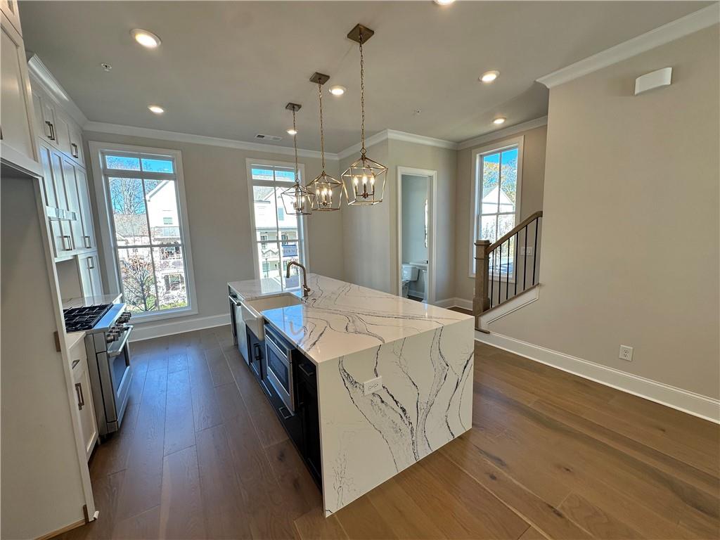 240 Briscoe Way, Unit 34 Alpharetta, GA 30009 - Photo 1 of 1 a kitchen with stainless steel appliances granite countertop a sink stove and refrigerator