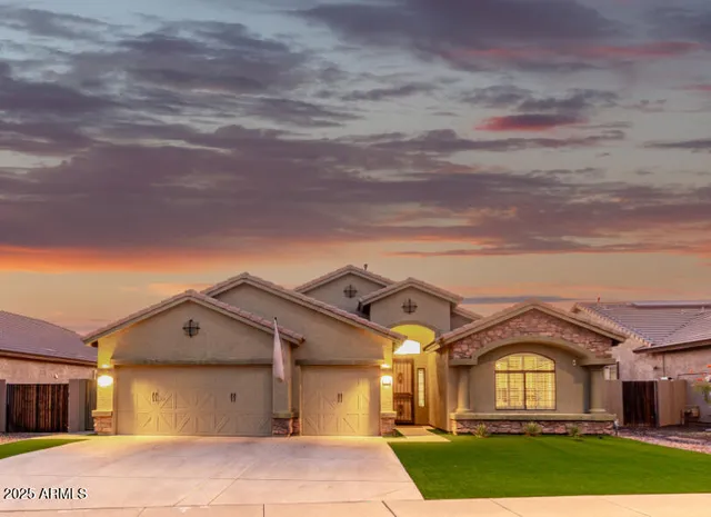 a view of a big house with a big yard and large tree