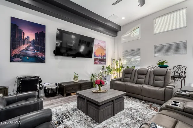 a dining room with furniture a chandelier and wooden floor