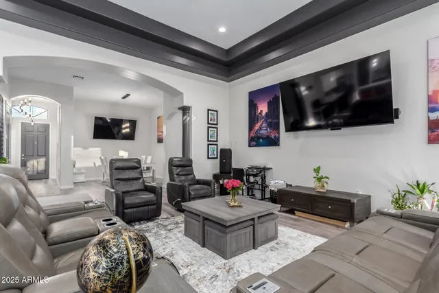 a kitchen with stainless steel appliances granite countertop a stove top oven a refrigerator a sink and chairs