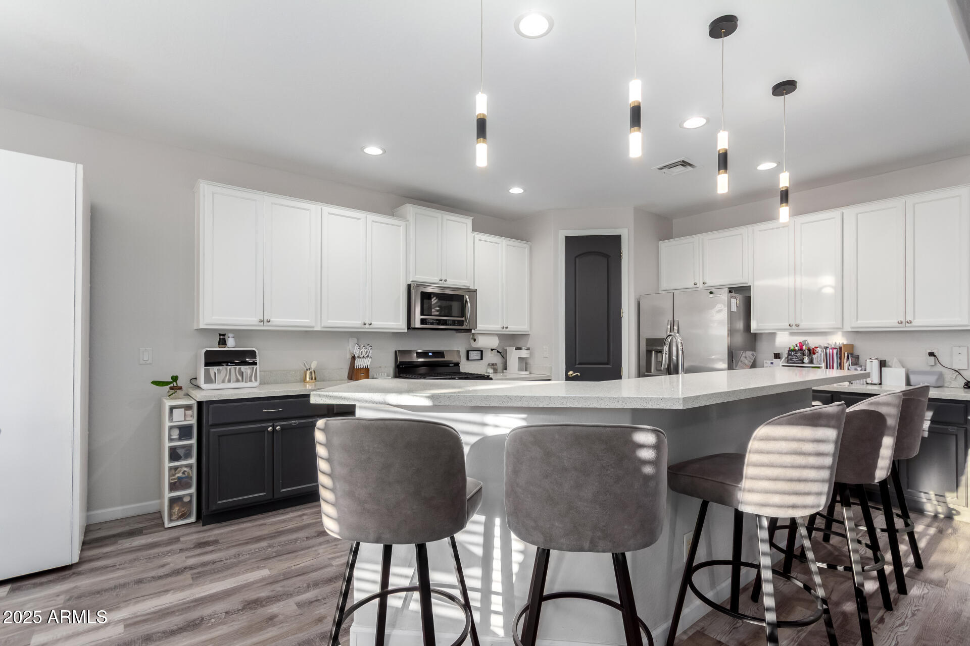 854 South Del Rio Court Apache Junction, AZ 85119 - Photo 21 of 57 a kitchen with stainless steel appliances granite countertop a stove top oven a refrigerator a sink and chairs