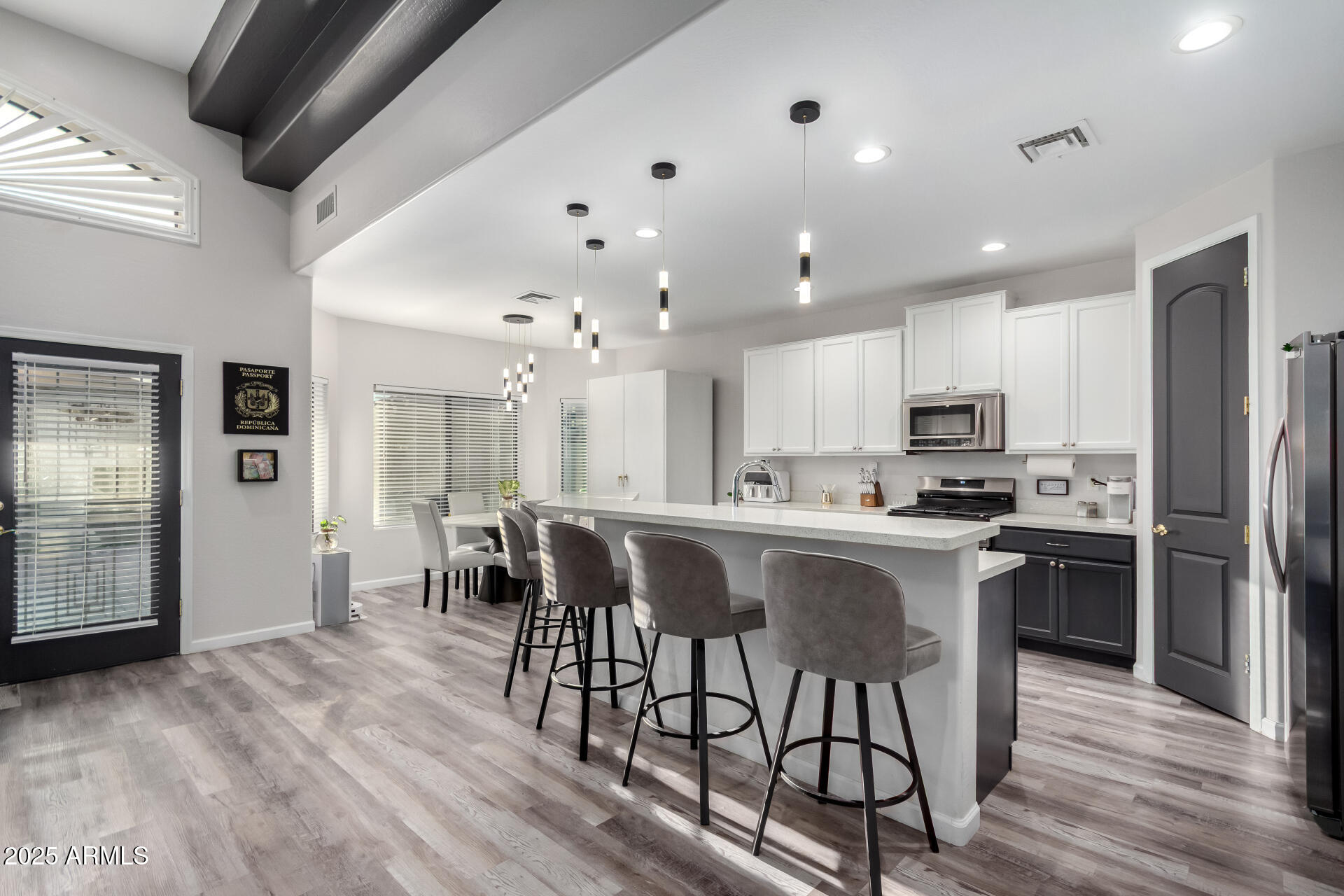 854 South Del Rio Court Apache Junction, AZ 85119 - Photo 22 of 57 an open kitchen with kitchen island wooden cabinets and stainless steel appliances