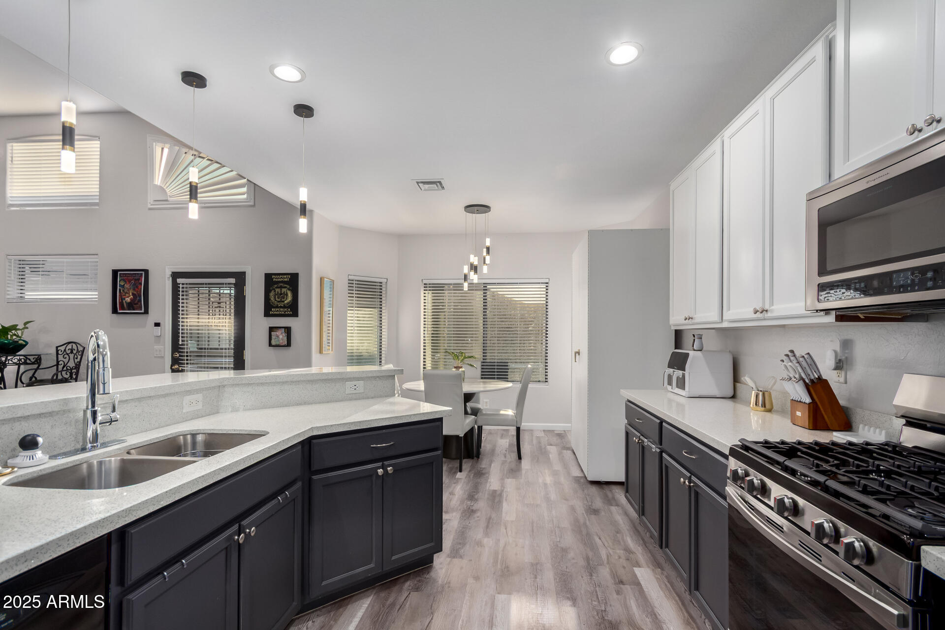 854 South Del Rio Court Apache Junction, AZ 85119 - Photo 23 of 57 a kitchen with stainless steel appliances a sink stove and cabinets