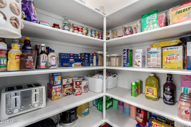 a bedroom with a bed a flat screen tv and a ceiling fan
