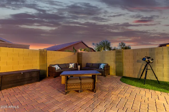 a swimming pool with outdoor seating and barbeque oven