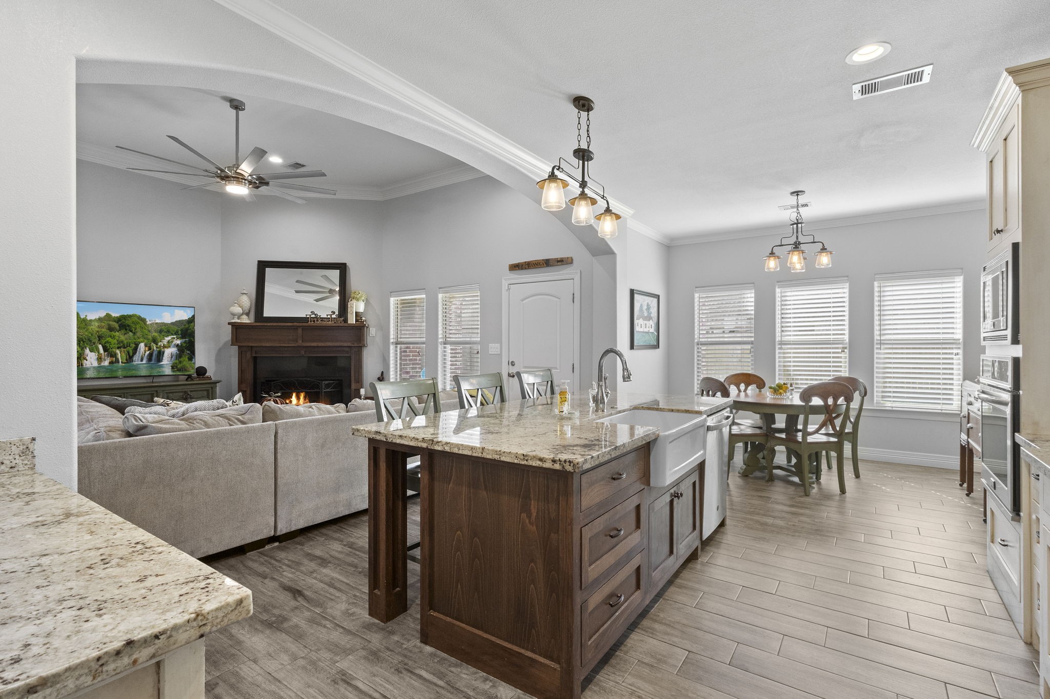 445 Bryant Boulevard Bridge City, TX 77611 - Photo 12 of 40 a large kitchen with kitchen island a dining table chairs and a wooden floor