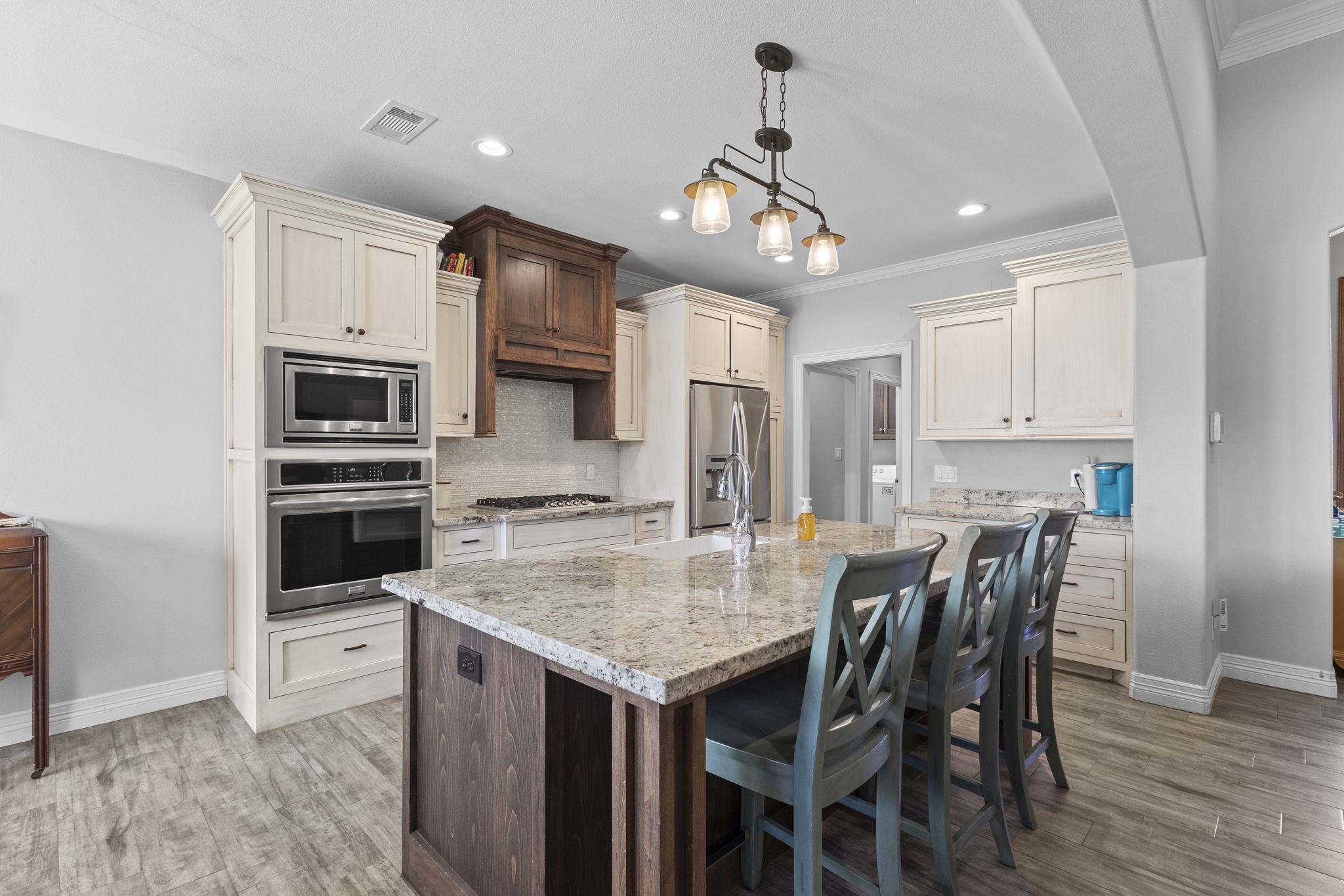 445 Bryant Boulevard Bridge City, TX 77611 - Photo 13 of 40 a kitchen with a table chairs microwave and refrigerator