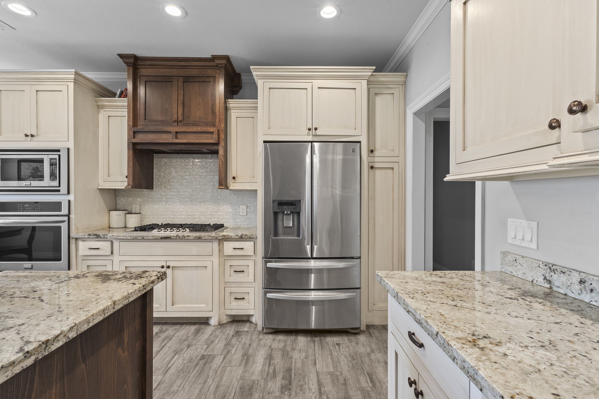 445 Bryant Boulevard Bridge City, TX 77611 - Photo 14 of 40 a kitchen with kitchen island granite countertop a stove refrigerator and microwave