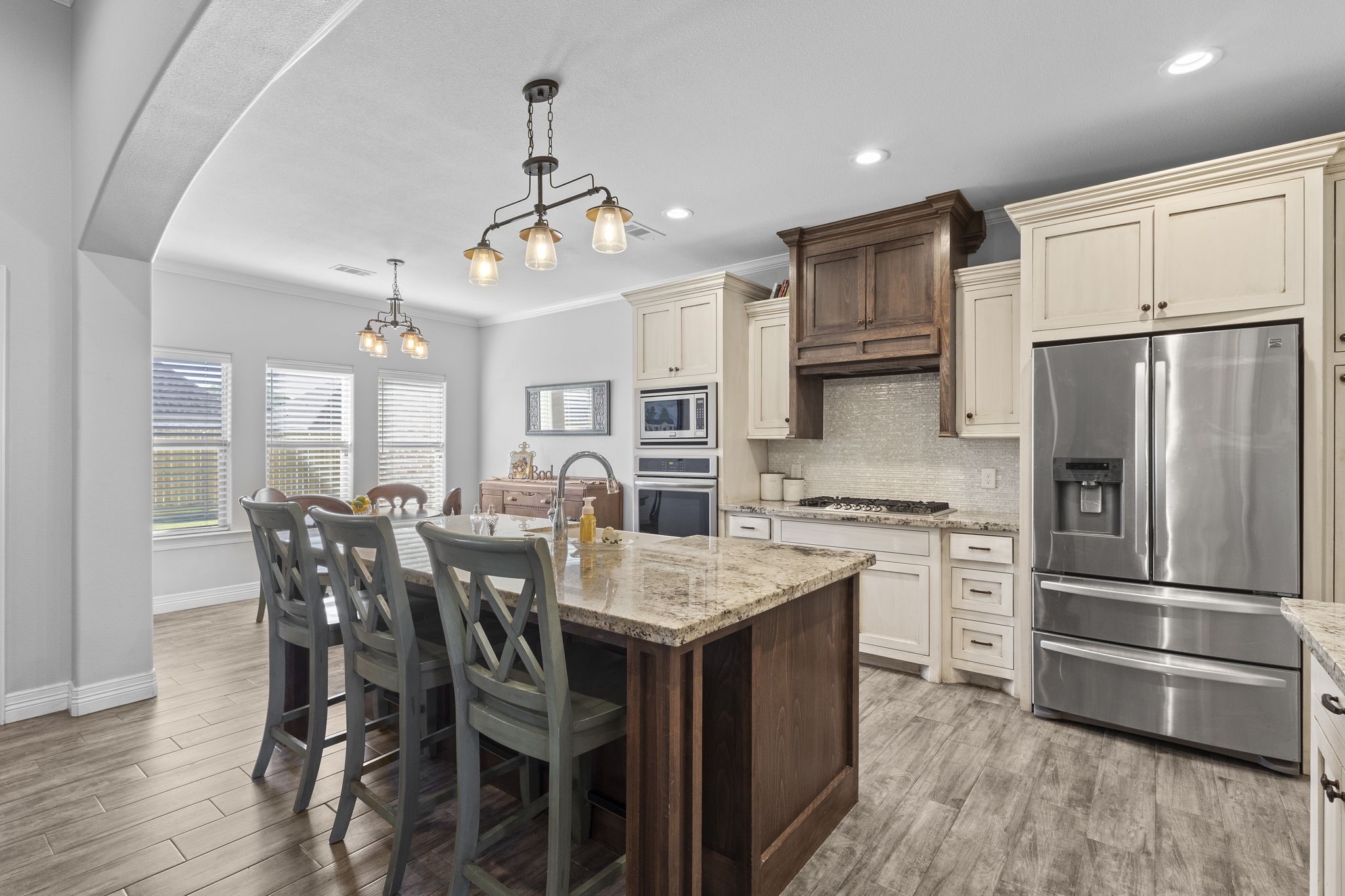 445 Bryant Boulevard Bridge City, TX 77611 - Photo 16 of 40 a kitchen with stainless steel appliances granite countertop a dining table chairs stove refrigerator and cabinets