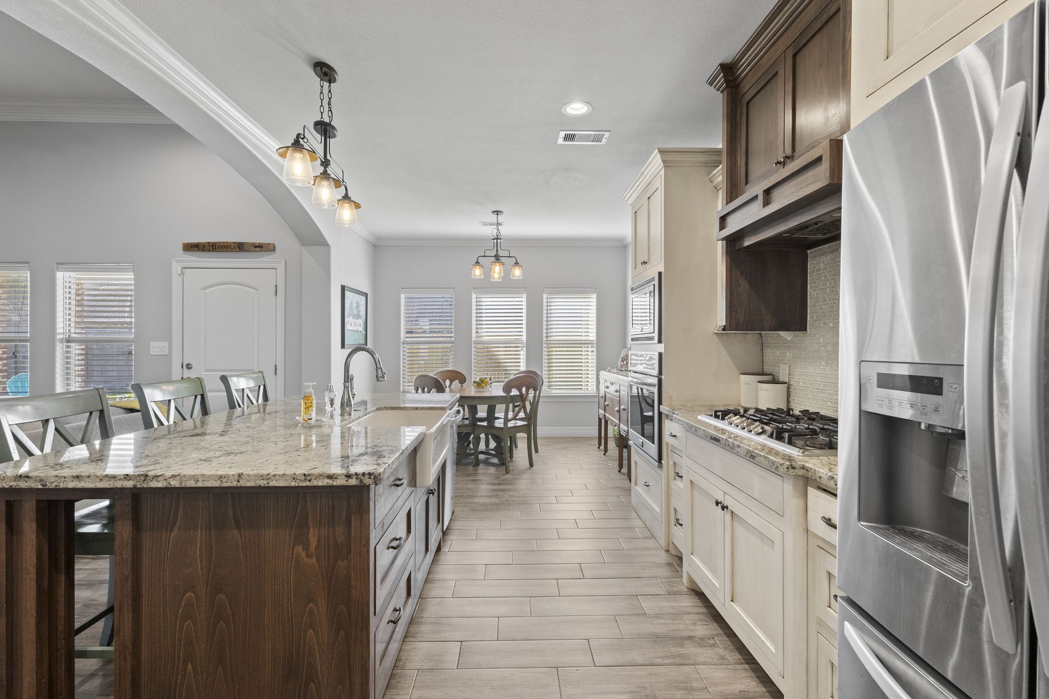 445 Bryant Boulevard Bridge City, TX 77611 - Photo 18 of 40 a large kitchen with stainless steel appliances granite countertop a lot of counter space and wooden floor