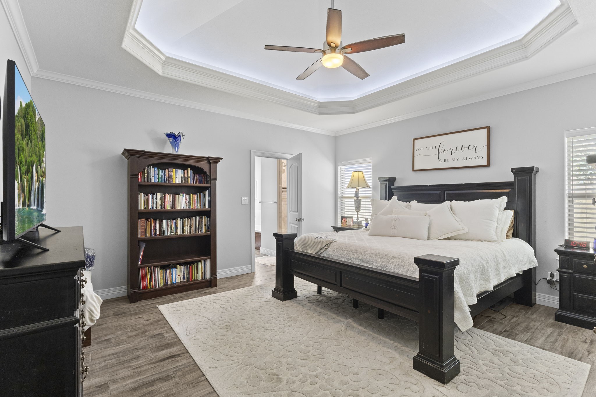 445 Bryant Boulevard Bridge City, TX 77611 - Photo 22 of 40 a spacious bedroom with a bed a dresser and a book shelf
