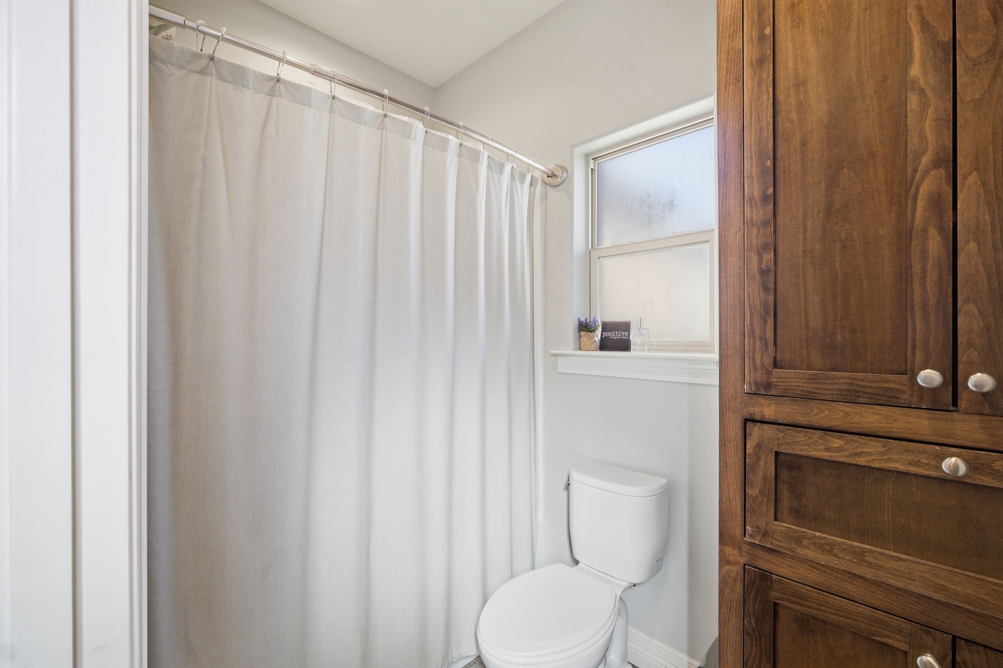 445 Bryant Boulevard Bridge City, TX 77611 - Photo 33 of 40 a white toilet sitting next to a shower curtain