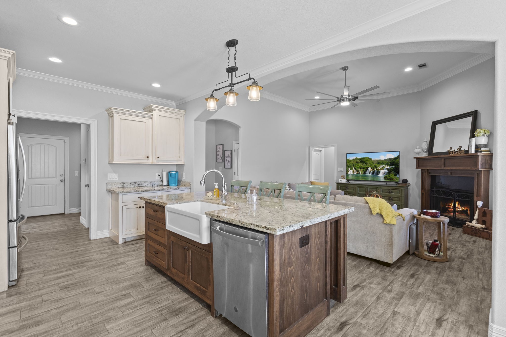 445 Bryant Boulevard Bridge City, TX 77611 - Photo 10 of 40 a view of a kitchen counter space wooden floor and a ceiling fan