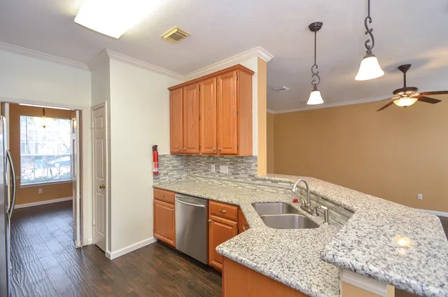 a kitchen with a stove and a wooden floor