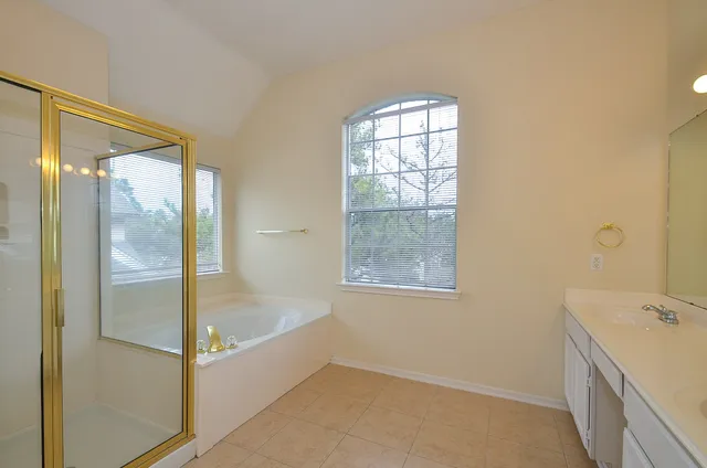a bathroom with a bathtub and shower