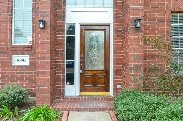 a view of a brick house with a large window