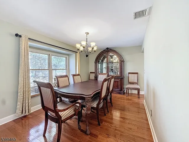 a view of a dining room with furniture and chandelier