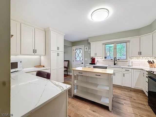 a kitchen that has a sink and a stove in it