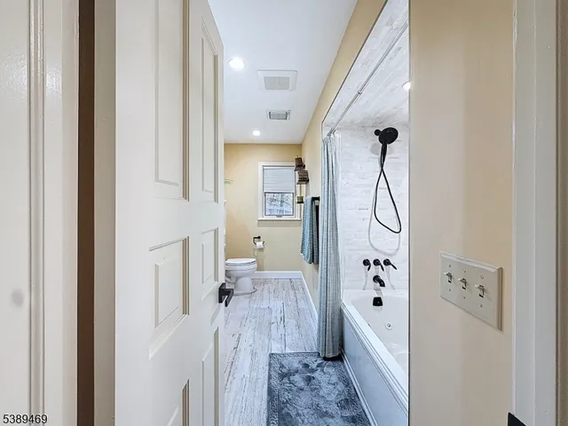 a view of living room kitchen and entryway