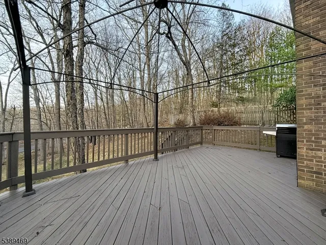 a view of a balcony with wooden floor and fence