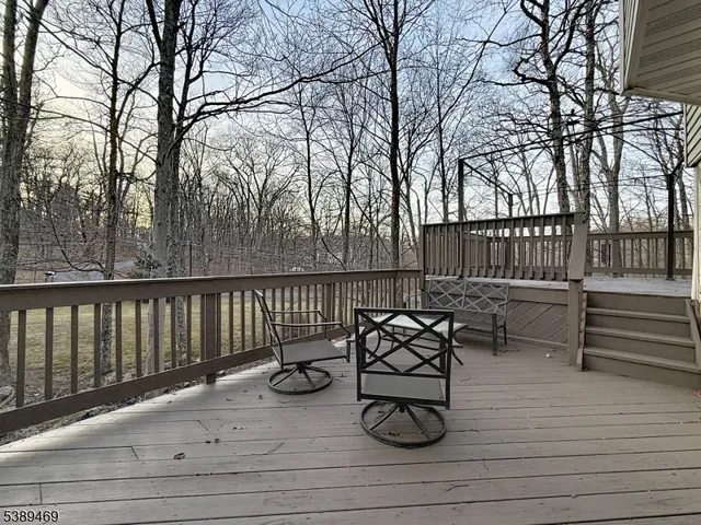 a view of a roof deck with furniture