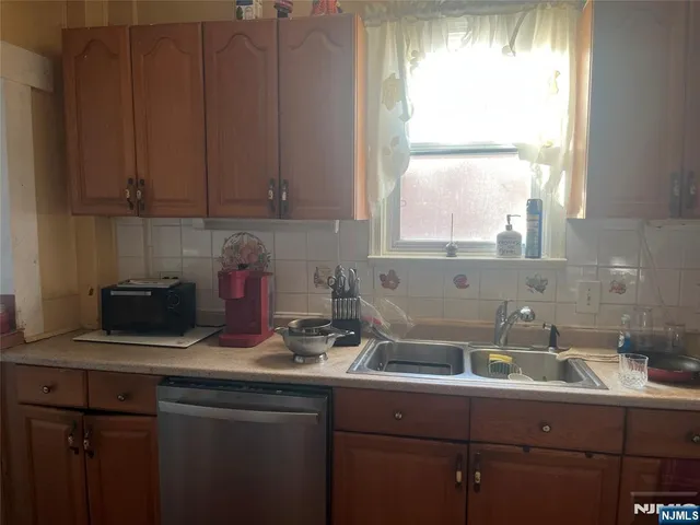 a kitchen with a sink cabinets and window
