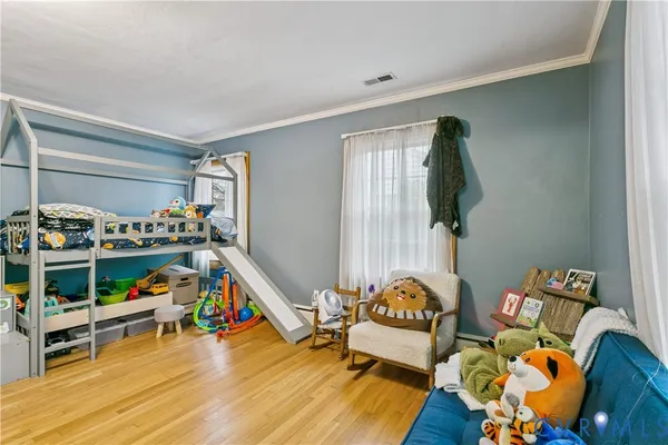 a bedroom with furniture and a wooden floor