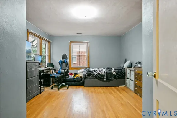 a living room with furniture window and wooden floor