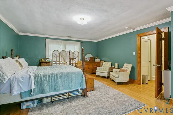 a spacious bedroom with two beds and painting on the wall