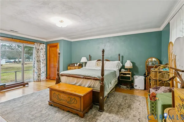 a spacious bedroom with a bed and large windows